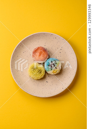 Chinese mooncake is an Asian sweet dessert. Asian mooncake as a background for your design 129993346