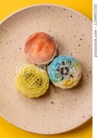 Chinese mooncake is an Asian sweet dessert. Asian mooncake as a background for your design Chinese mooncake is an Asian sweet dessert. Asian mooncake as a background for your design 129993350