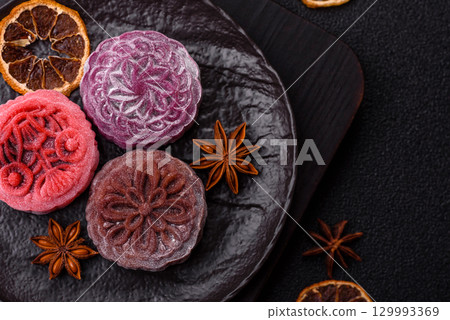 Chinese mooncake is an Asian sweet dessert. Asian mooncake as a background for your design 129993369