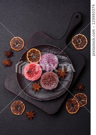 Chinese mooncake is an Asian sweet dessert. Asian mooncake as a background for your design 129993374