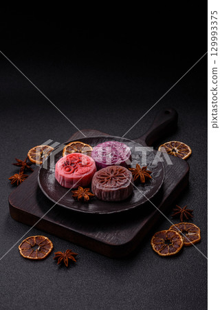 Chinese mooncake is an Asian sweet dessert. Asian mooncake as a background for your design 129993375