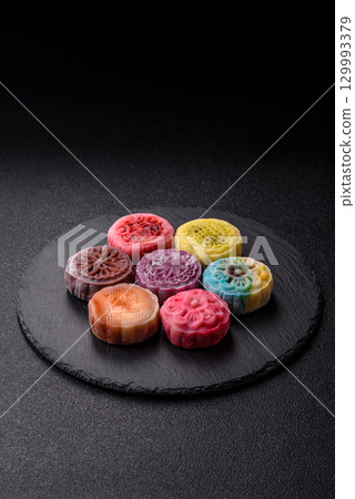 Chinese mooncake is an Asian sweet dessert. Asian mooncake as a background for your design 129993379