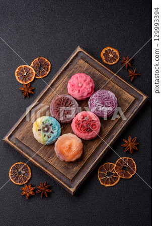 Chinese mooncake is an Asian sweet dessert. Asian mooncake as a background for your design Chinese mooncake is an Asian sweet dessert. Asian mooncake as a background for your design 129993394