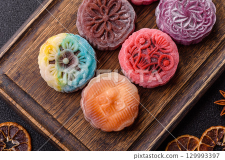 Chinese mooncake is an Asian sweet dessert. Asian mooncake as a background for your design Chinese mooncake is an Asian sweet dessert. Asian mooncake as a background for your design 129993397