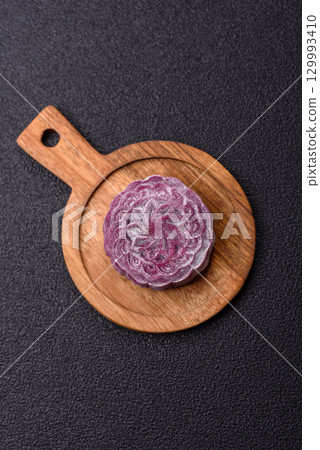 Chinese mooncake is an Asian sweet dessert. Asian mooncake as a background for your design Chinese mooncake is an Asian sweet dessert. Asian mooncake as a background for your design 129993410