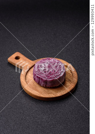 Chinese mooncake is an Asian sweet dessert. Asian mooncake as a background for your design Chinese mooncake is an Asian sweet dessert. Asian mooncake as a background for your design 129993411