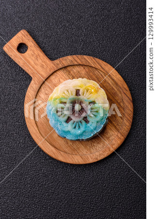 Chinese mooncake is an Asian sweet dessert. Asian mooncake as a background for your design Chinese mooncake is an Asian sweet dessert. Asian mooncake as a background for your design 129993414