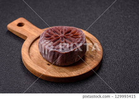 Chinese mooncake is an Asian sweet dessert. Asian mooncake as a background for your design Chinese mooncake is an Asian sweet dessert. Asian mooncake as a background for your design 129993415