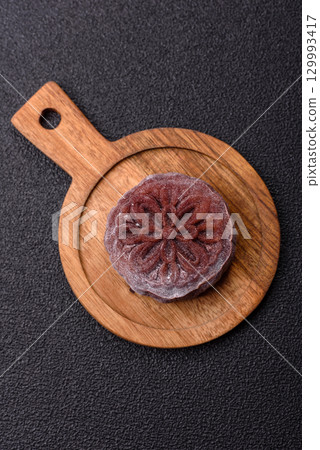 Chinese mooncake is an Asian sweet dessert. Asian mooncake as a background for your design Chinese mooncake is an Asian sweet dessert. Asian mooncake as a background for your design 129993417