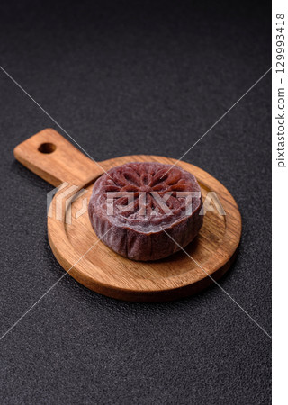 Chinese mooncake is an Asian sweet dessert. Asian mooncake as a background for your design Chinese mooncake is an Asian sweet dessert. Asian mooncake as a background for your design 129993418
