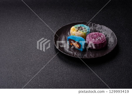 Chinese mooncake is an Asian sweet dessert. Asian mooncake as a background for your design Chinese mooncake is an Asian sweet dessert. Asian mooncake as a background for your design 129993419