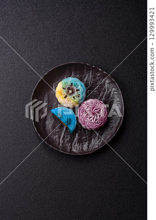 Chinese mooncake is an Asian sweet dessert. Asian mooncake as a background for your design Chinese mooncake is an Asian sweet dessert. Asian mooncake as a background for your design 129993421