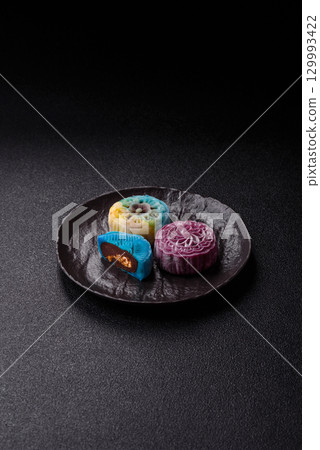 Chinese mooncake is an Asian sweet dessert. Asian mooncake as a background for your design 129993422