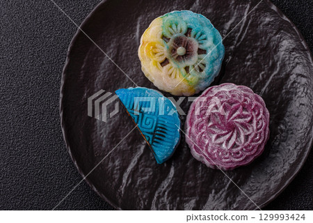 Chinese mooncake is an Asian sweet dessert. Asian mooncake as a background for your design Chinese mooncake is an Asian sweet dessert. Asian mooncake as a background for your design 129993424