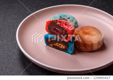 Chinese mooncake is an Asian sweet dessert. Asian mooncake as a background for your design 129993427