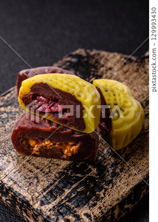 Chinese mooncake is an Asian sweet dessert. Asian mooncake as a background for your design 129993430