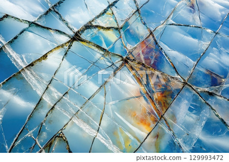 Abstract macro of cracked ice with colorful light refracting through the fractures Abstract macro of cracked ice with colorful light refracting through the fractures 129993472