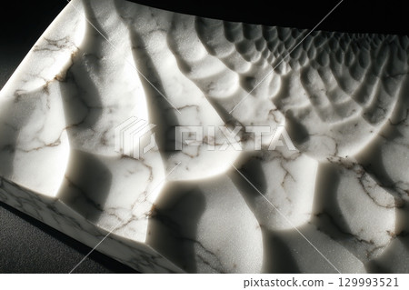 Abstract topographic patterns carved into marble with shadows Abstract topographic patterns carved into marble with shadows 129993521