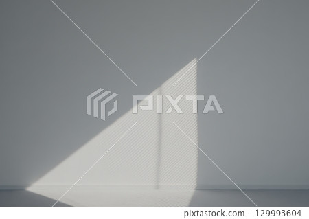 Geometric shadow play on minimalist white wall from blinds abstract architectural composition Geometric shadow play on minimalist white wall from blinds abstract architectural composition 129993604