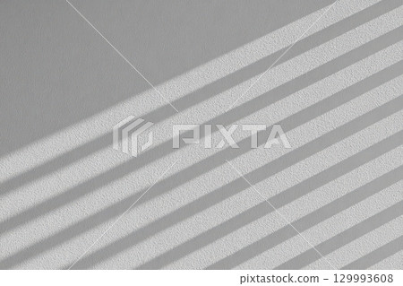 Geometric shadow play on minimalist white wall from blinds abstract architectural composition Geometric shadow play on minimalist white wall from blinds abstract architectural composition 129993608