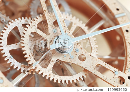 Close-up of golden gears turning inside vintage clock mechanism steampunk texture study Close-up of golden gears turning inside vintage clock mechanism steampunk texture study 129993660