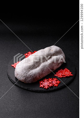 Christmas Stollen, a German sweet cake with marzipan and fruit. Winter Christmas Stollen 129994100