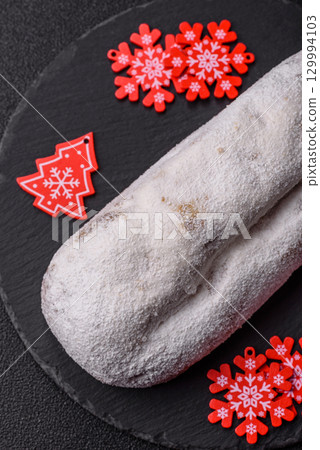 Christmas Stollen, a German sweet cake with marzipan and fruit. Winter Christmas Stollen 129994103