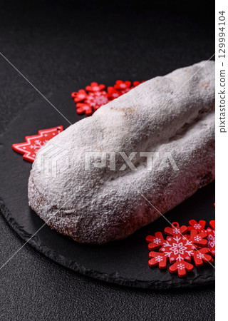 Christmas Stollen, a German sweet cake with marzipan and fruit. Winter Christmas Stollen 129994104