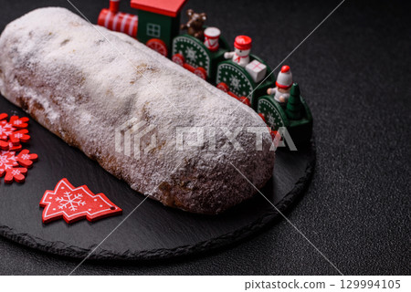 Christmas Stollen, a German sweet cake with marzipan and fruit. Winter Christmas Stollen 129994105