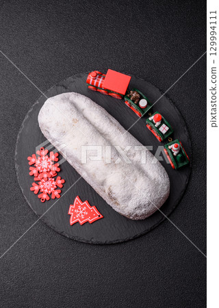 Christmas Stollen, a German sweet cake with marzipan and fruit. Winter Christmas Stollen 129994111