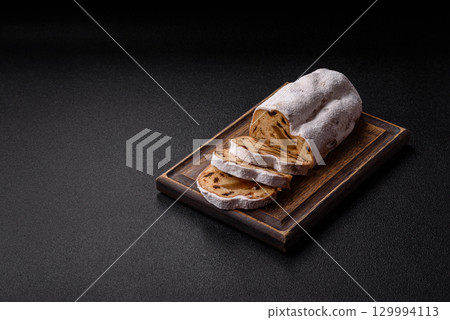 Christmas Stollen, a German sweet cake with marzipan and fruit. Winter Christmas Stollen 129994113