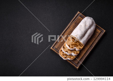 Christmas Stollen, a German sweet cake with marzipan and fruit. Winter Christmas Stollen 129994114