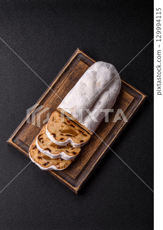 Christmas Stollen, a German sweet cake with marzipan and fruit. Winter Christmas Stollen 129994115