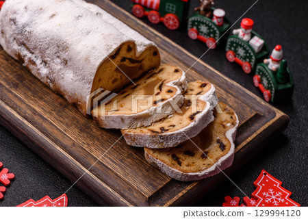 Christmas Stollen, a German sweet cake with marzipan and fruit. Winter Christmas Stollen 129994120
