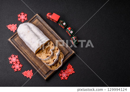 Christmas Stollen, a German sweet cake with marzipan and fruit. Winter Christmas Stollen 129994124