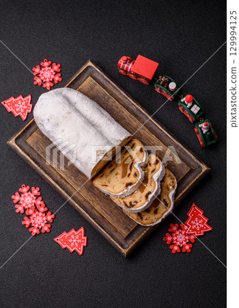 Christmas Stollen, a German sweet cake with marzipan and fruit. Winter Christmas Stollen 129994125