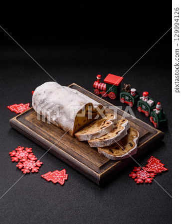 Christmas Stollen, a German sweet cake with marzipan and fruit. Winter Christmas Stollen 129994126