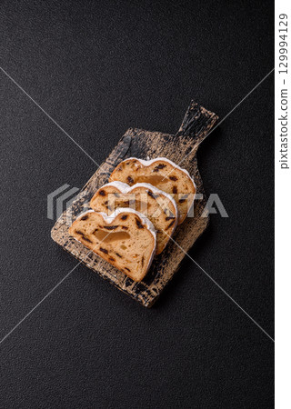 Christmas Stollen, a German sweet cake with marzipan and fruit. Winter Christmas Stollen 129994129