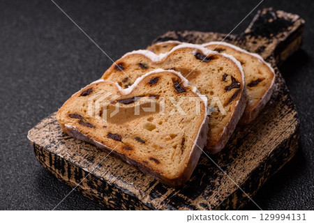 Christmas Stollen, a German sweet cake with marzipan and fruit. Winter Christmas Stollen 129994131