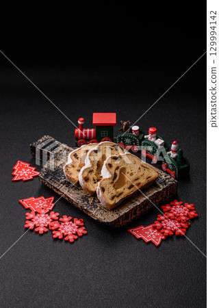 Christmas Stollen, a German sweet cake with marzipan and fruit. Winter Christmas Stollen 129994142