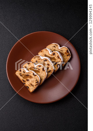 Christmas Stollen, a German sweet cake with marzipan and fruit. Winter Christmas Stollen 129994145