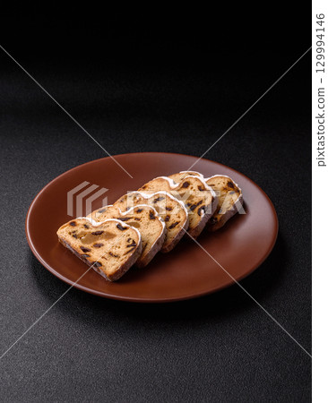 Christmas Stollen, a German sweet cake with marzipan and fruit. Winter Christmas Stollen 129994146