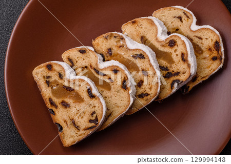 Christmas Stollen, a German sweet cake with marzipan and fruit. Winter Christmas Stollen 129994148