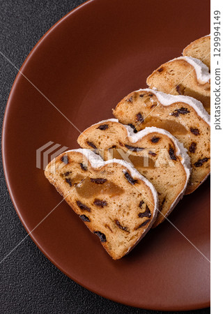 Christmas Stollen, a German sweet cake with marzipan and fruit. Winter Christmas Stollen Christmas Stollen, a German sweet cake with marzipan and fruit. Winter Christmas Stollen 129994149