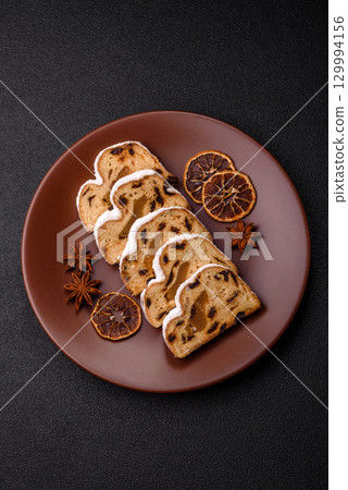 Christmas Stollen, a German sweet cake with marzipan and fruit. Winter Christmas Stollen 129994156