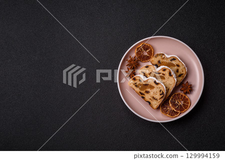 Christmas Stollen, a German sweet cake with marzipan and fruit. Winter Christmas Stollen 129994159
