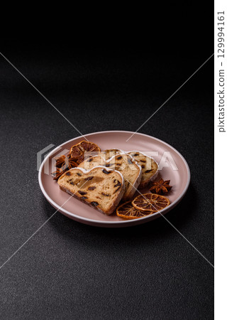 Christmas Stollen, a German sweet cake with marzipan and fruit. Winter Christmas Stollen Christmas Stollen, a German sweet cake with marzipan and fruit. Winter Christmas Stollen 129994161