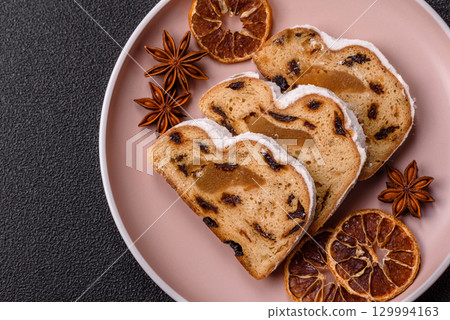Christmas Stollen, a German sweet cake with marzipan and fruit. Winter Christmas Stollen 129994163