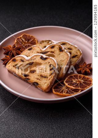 Christmas Stollen, a German sweet cake with marzipan and fruit. Winter Christmas Stollen Christmas Stollen, a German sweet cake with marzipan and fruit. Winter Christmas Stollen 129994165