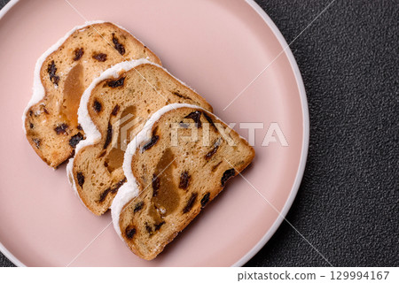 Christmas Stollen, a German sweet cake with marzipan and fruit. Winter Christmas Stollen Christmas Stollen, a German sweet cake with marzipan and fruit. Winter Christmas Stollen 129994167